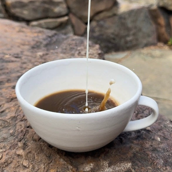 Cup of brewed Organic Hojicha tea showing a warm amber color with a smooth, toasty flavor profile