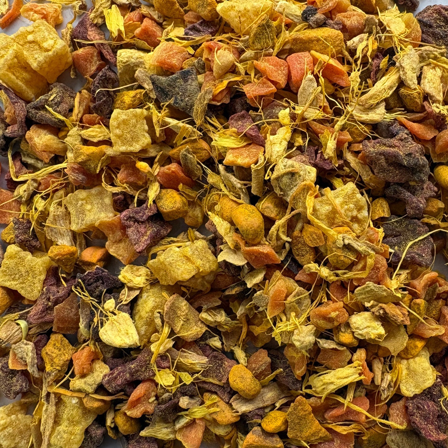 Teadaytea Golden herbal tea blend with anti-inflammatory ginger and turmeric root, dried pineapple, and calendula petals.