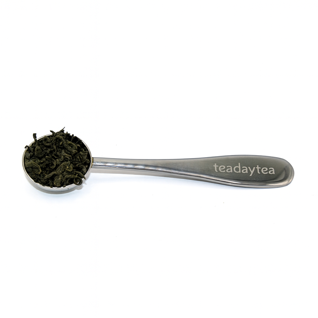 Tea spoon with tea leaves and 'teadaytea' branding on a white background