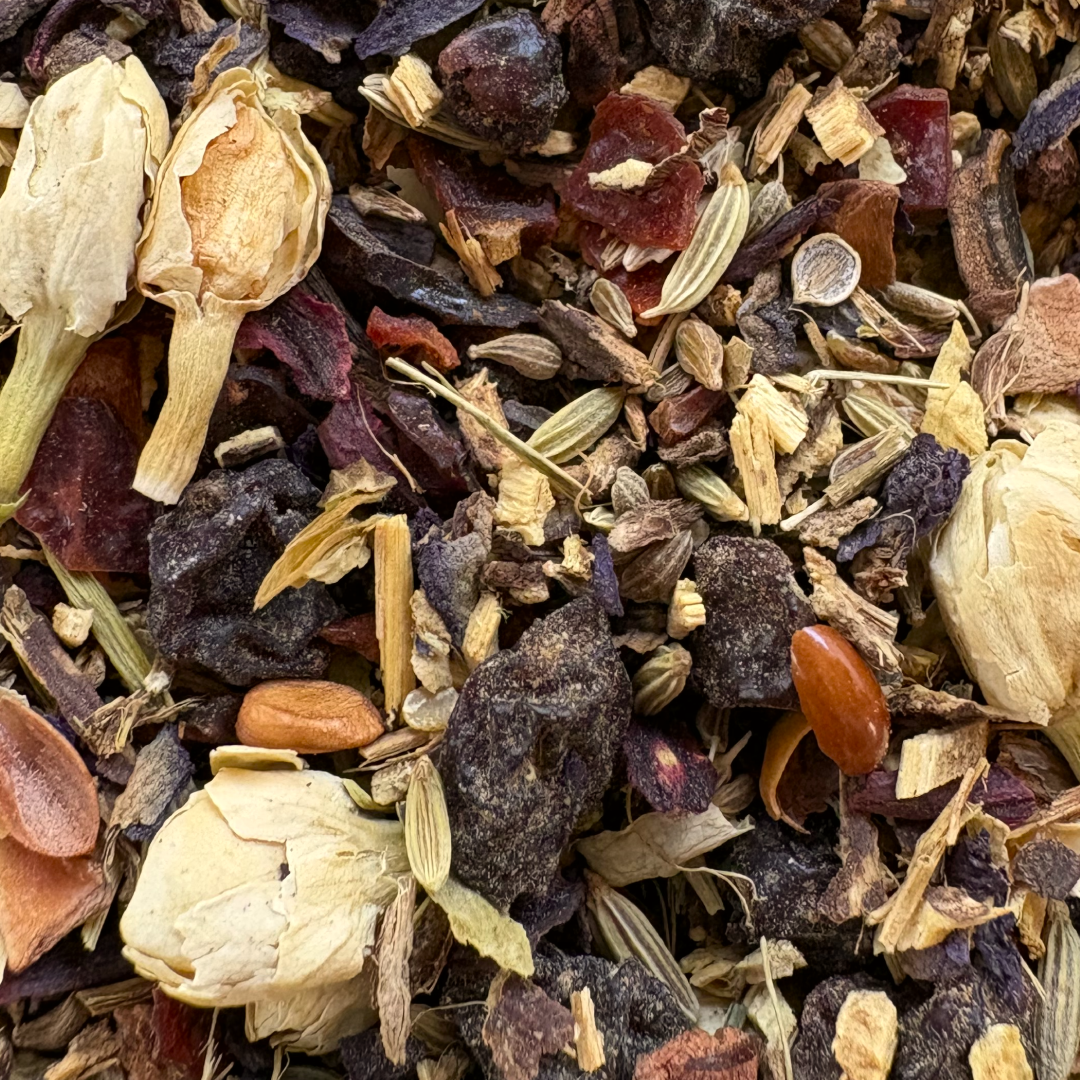 Close up of Teadaytea Blue Butterfly Digestif premium loose-leaf herbal tea blend featuring anise, licorice, and fennel seeds mixed with dried hibiscus and vibrant blue butterfly pea flowers.