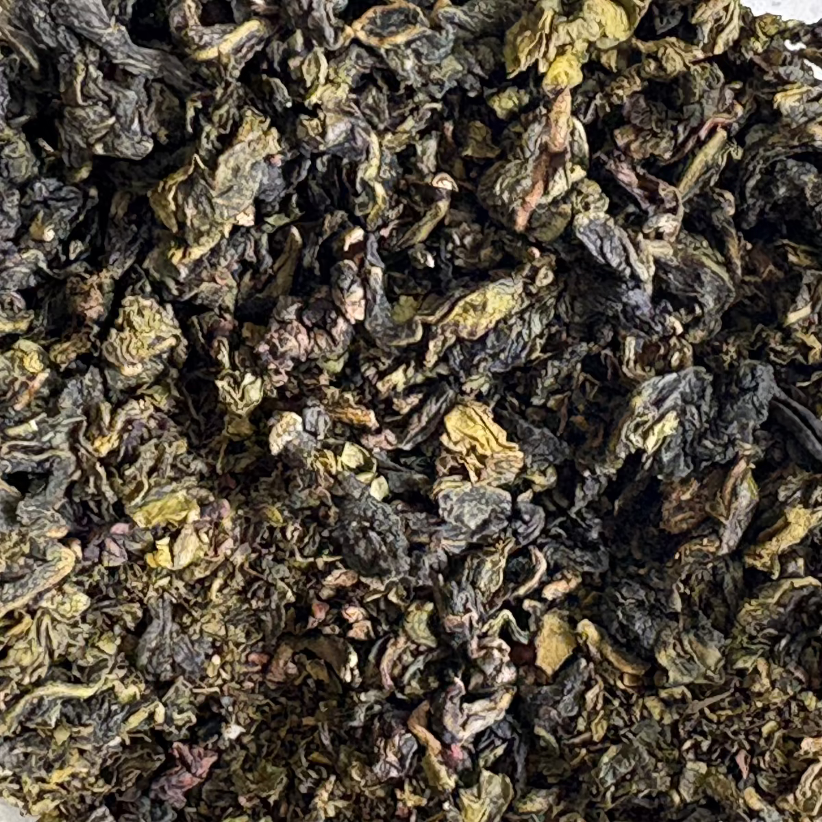 Teadaytea Quanzhou Milky Oolong premium loose-leaf pure tea showing tightly rolled jade-green oolong leaves.